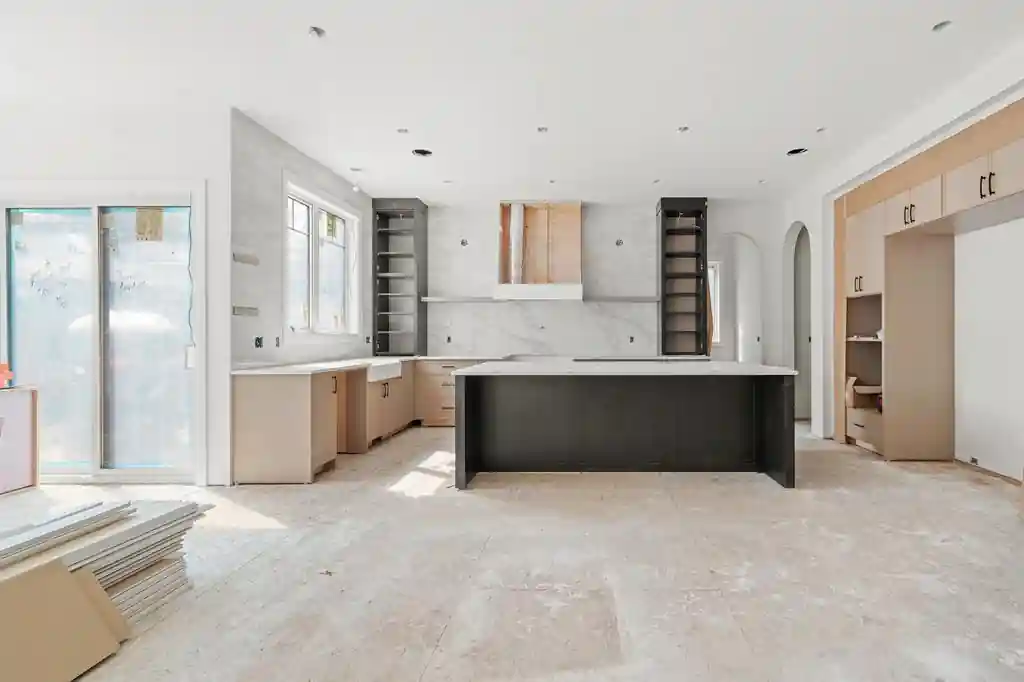 Custom home kitchen with cabinetry and countertops illustrating how interior finish selections can increase construction costs.
