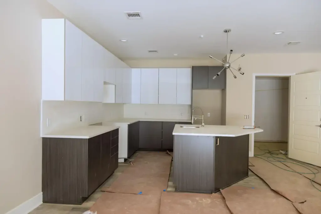 Partially finished new home kitchen showing cabinetry and countertop installation during residential construction.