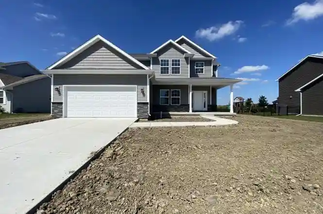 Newly constructed home with unfinished landscaping and driveway illustrating often overlooked final construction expenses.