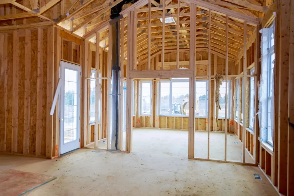 Wooden framing and roof structure of a new house illustrating the owner builder construction process.