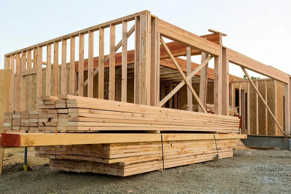 Organized lumber and building materials at a residential construction site for efficient project management.